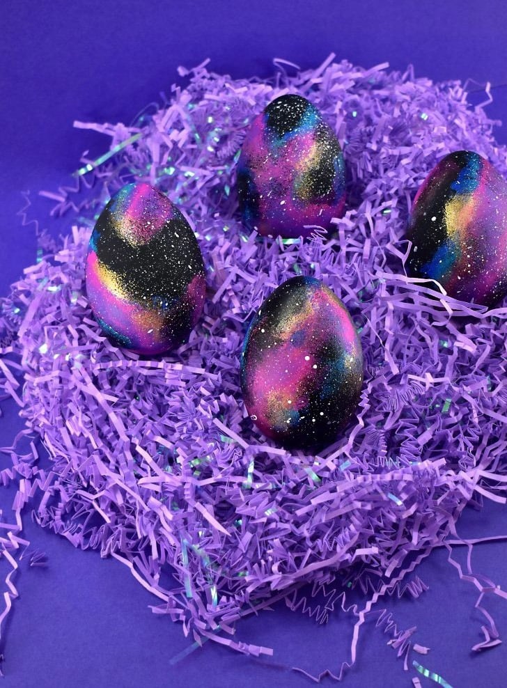 purple galaxy eggs that are painted for a plastic egg activity 