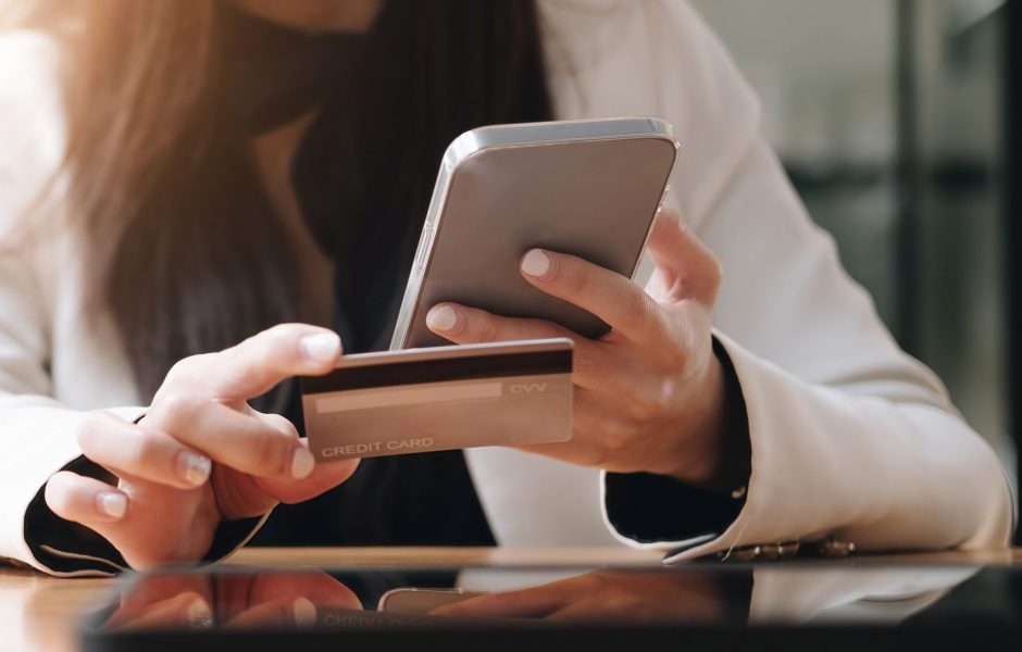 woman making a payment on a mobile phone