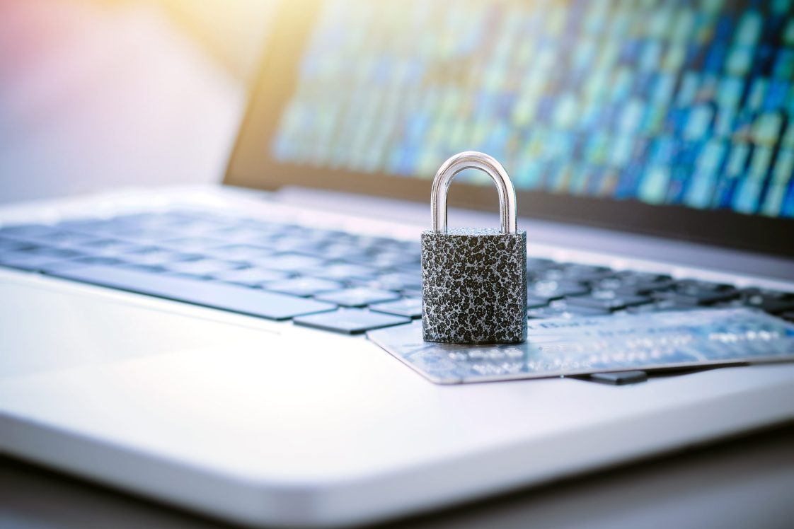 padlock on top of a credit card thats on top of a laptop