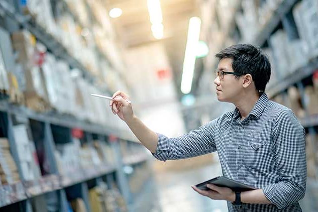 man doing inventory in warehouse