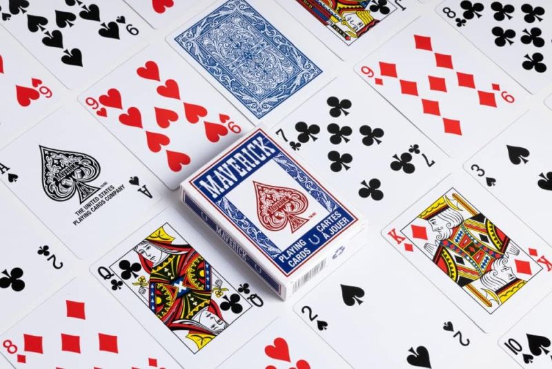 Playing cards laid out on a table with a box on top