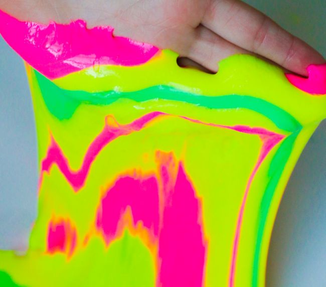 Student playing with neon colored slime 