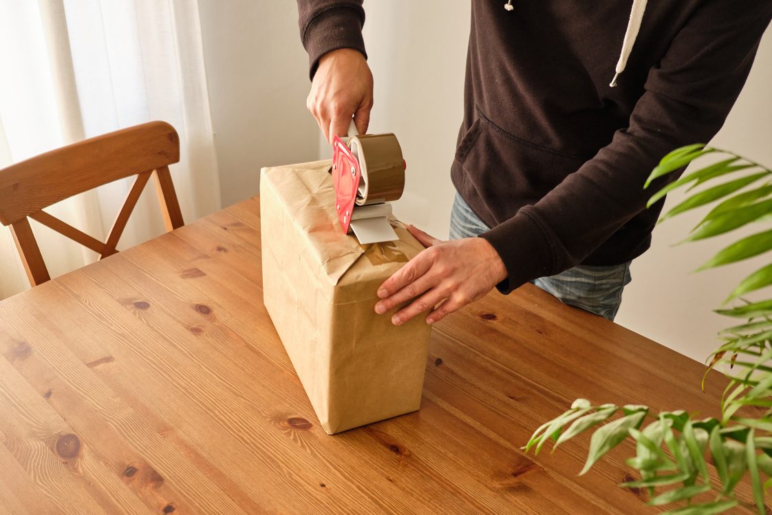 customer taping up a package to be returned