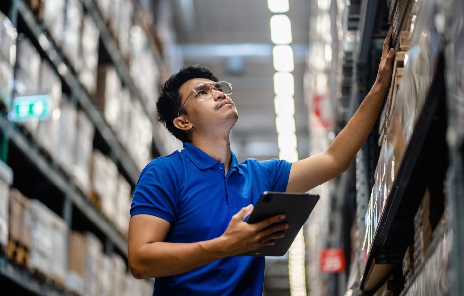 concerned warehouse worker doing inventory