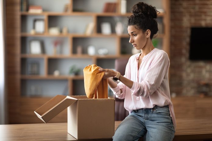 woman opening up package in her office