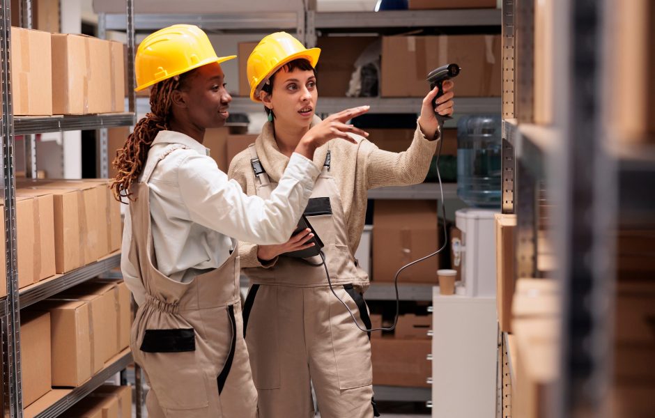 workers using scanner on inventory in warehouse