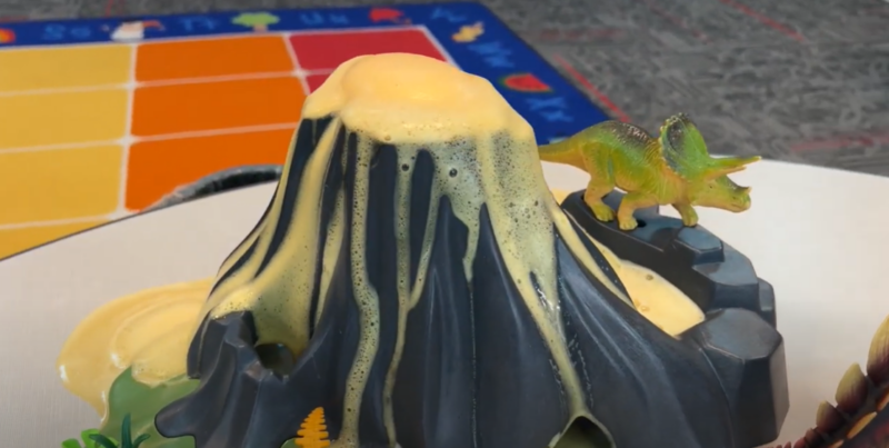 A plastic volcano is seen erupting.