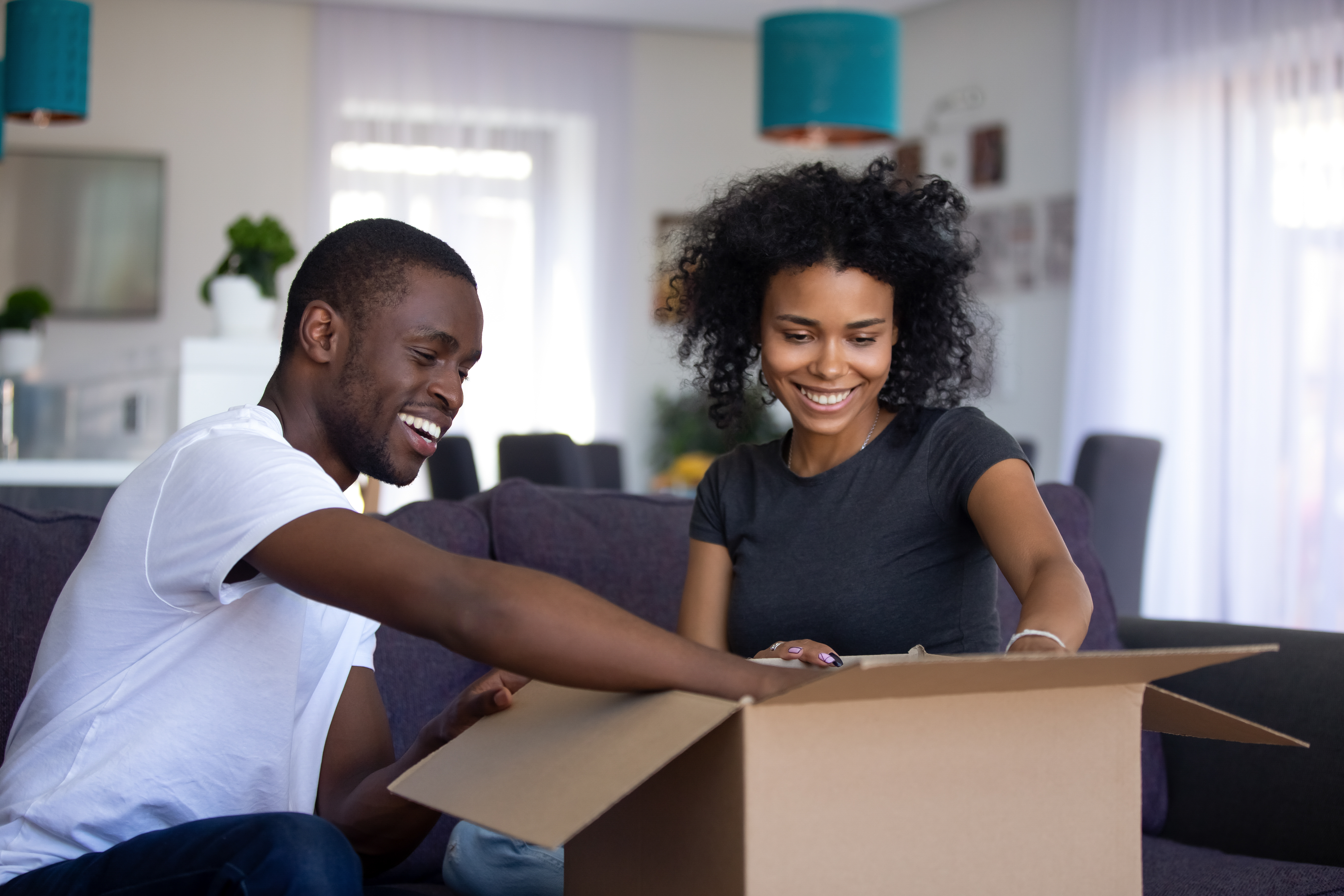 young couple opening up a package they just received